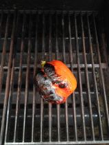 Charred pepper on grill.